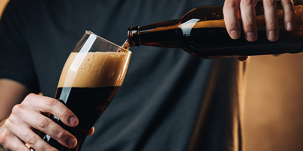 woman working at a desk with laptop and cat looking out the window in a cozy home office environment featuring seven essential work from home tips